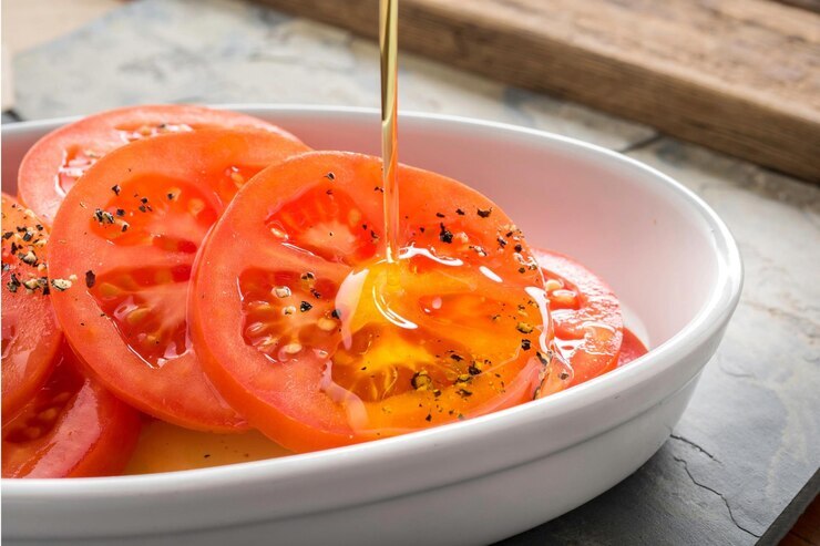 This image has an empty alt attribute; its file name is 4k-image-pouring-olive-oil-fresh-tomato-closeup-shot_944008-3468-1.jpg